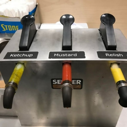 condiment dispenser with ketchup, mustard, and relish in wrong spots