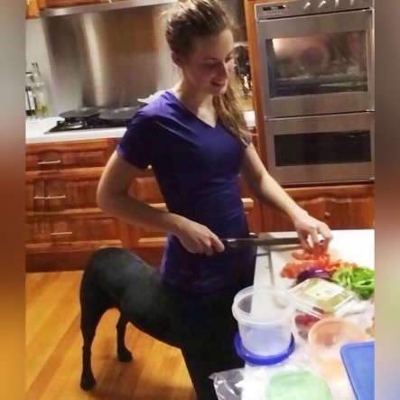 girl cooking and looks like she has a dog as her lower body