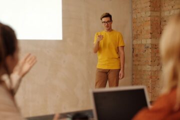 Free Man Wearing a Yellow Shirt Doing a Presentation Stock Photo